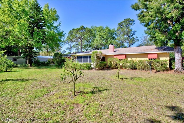 view of yard with a sunroom