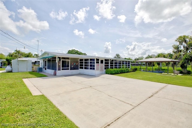1644 Heron Dr S, Lorida, FL 33857 - view of front of home featuring a front yard, a gazebo, central AC, and a sunroom