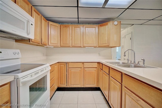 1644 Heron Dr S, Lorida, FL 33857 - kitchen with light brown cabinetry, sink, light tile patterned floors, and white appliances