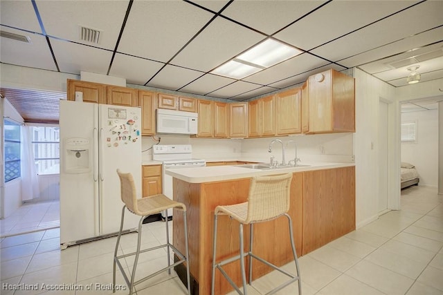 1644 Heron Dr S, Lorida, FL 33857 - kitchen with a breakfast bar, light brown cabinets, white appliances, and sink