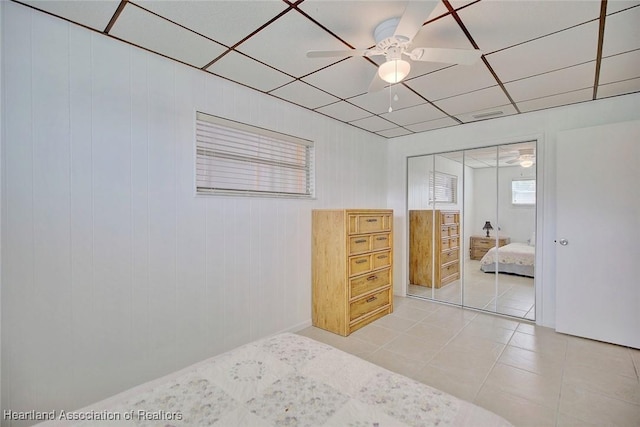 1644 Heron Dr S, Lorida, FL 33857 - tiled bedroom with ceiling fan, a closet, a drop ceiling, and wood walls