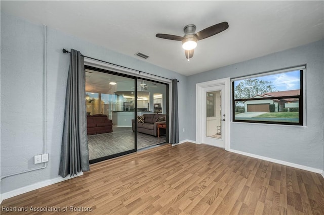 unfurnished room featuring light hardwood / wood-style flooring and ceiling fan