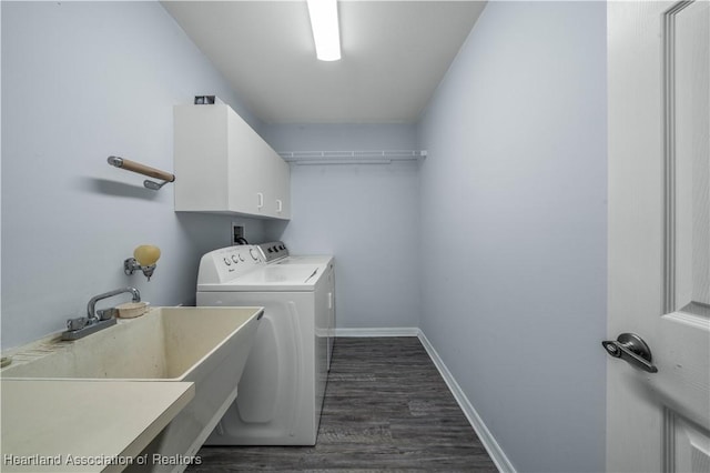 laundry area with cabinets, dark hardwood / wood-style flooring, sink, and independent washer and dryer