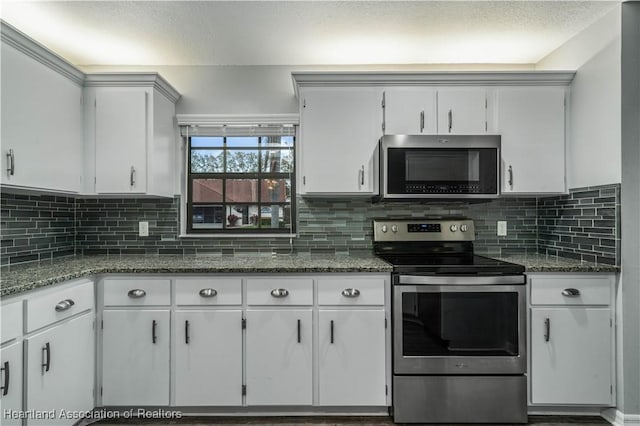 kitchen with stainless steel appliances, tasteful backsplash, and white cabinets