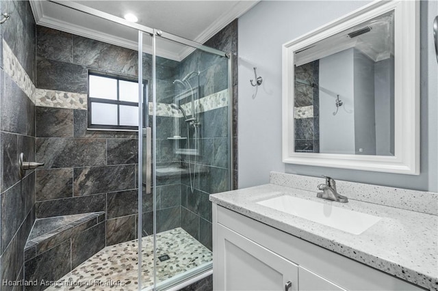 bathroom featuring ornamental molding, an enclosed shower, and vanity