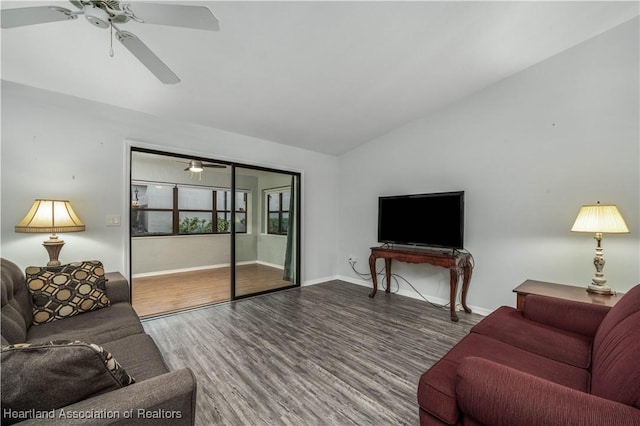 living room with ceiling fan, lofted ceiling, and wood-type flooring