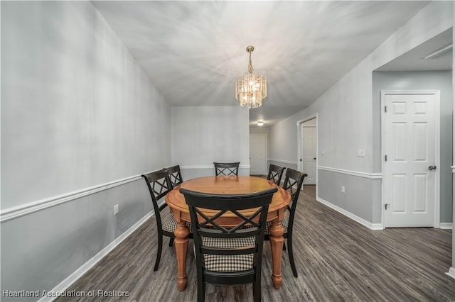 dining area featuring dark hardwood / wood-style flooring and a chandelier