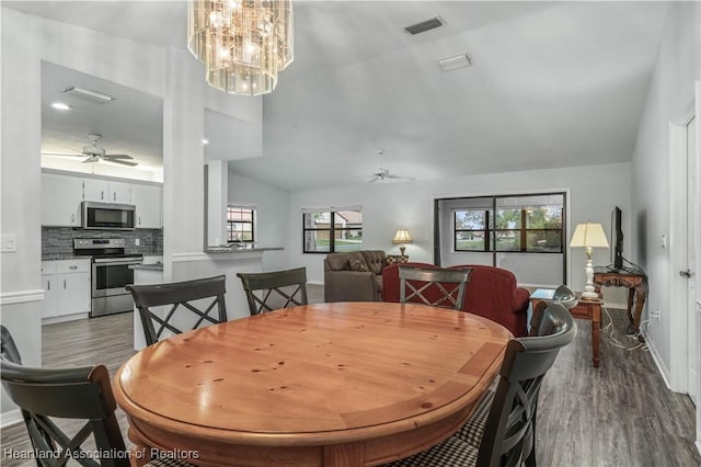 dining area with ceiling fan, vaulted ceiling, and a healthy amount of sunlight