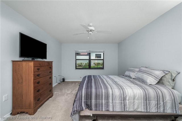 bedroom featuring light carpet and ceiling fan