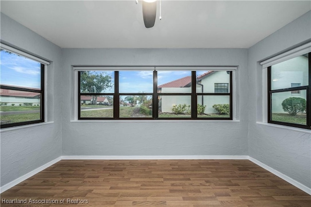 spare room with hardwood / wood-style flooring and ceiling fan