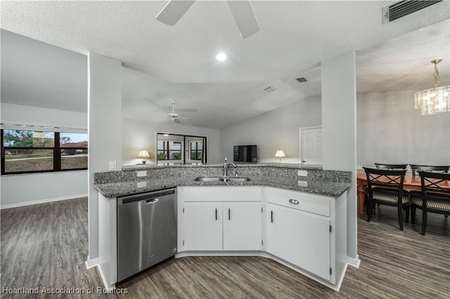 kitchen with vaulted ceiling, sink, white cabinets, dark stone counters, and stainless steel dishwasher