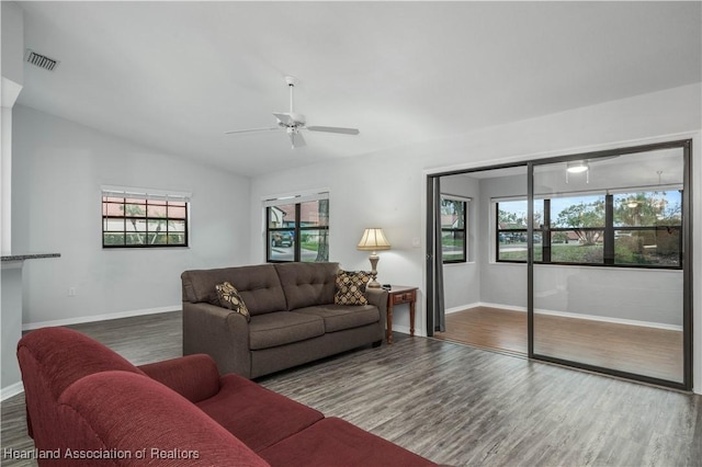 living room featuring lofted ceiling, plenty of natural light, and dark hardwood / wood-style flooring