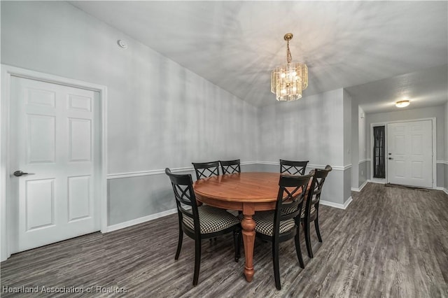 dining area featuring an inviting chandelier and dark hardwood / wood-style flooring