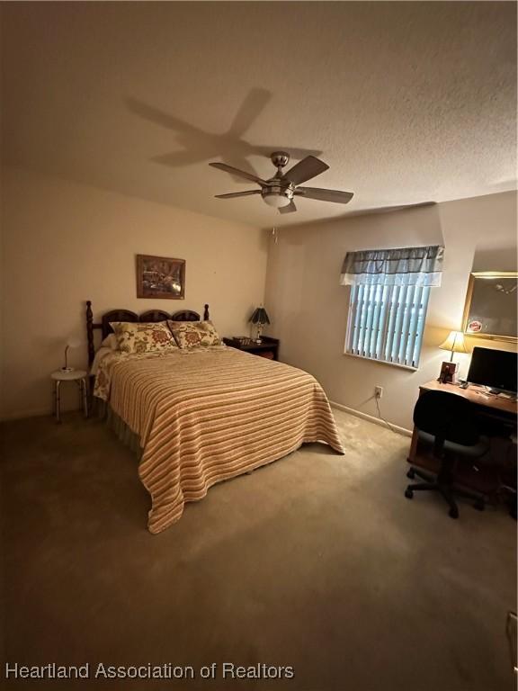 bedroom with ceiling fan and carpet flooring