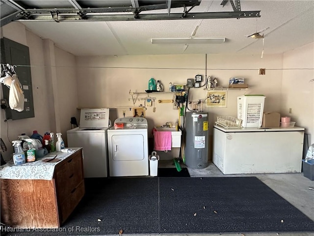 interior space featuring electric water heater, independent washer and dryer, a garage, and laundry area