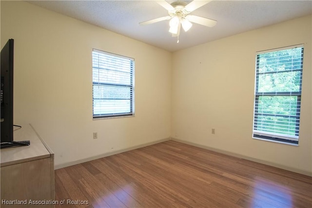 unfurnished room featuring ceiling fan and hardwood / wood-style flooring