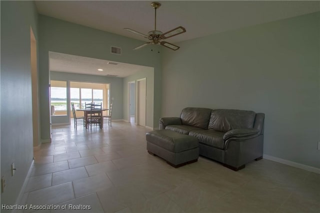 living room with ceiling fan and light tile patterned floors