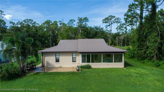 rear view of property with a patio area and a yard