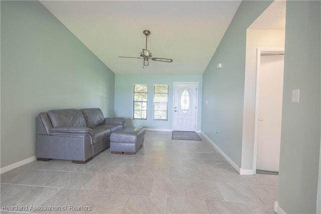 tiled living room featuring ceiling fan and lofted ceiling