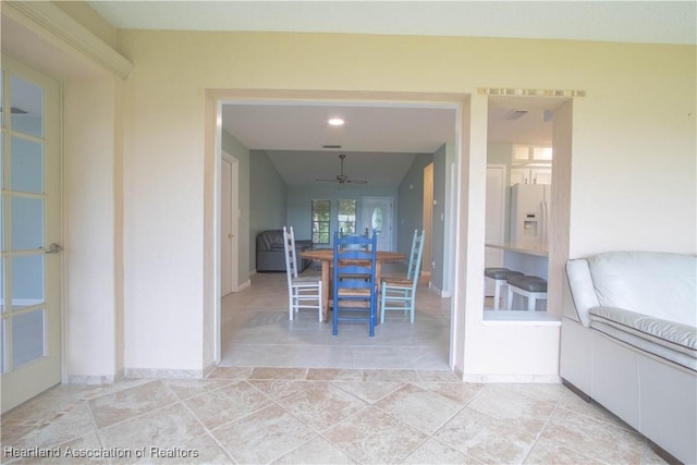 unfurnished dining area featuring ceiling fan and light tile patterned floors