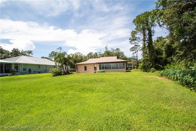 view of yard with a sunroom