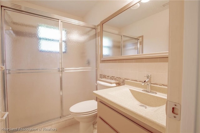 bathroom featuring an enclosed shower, decorative backsplash, toilet, and vanity