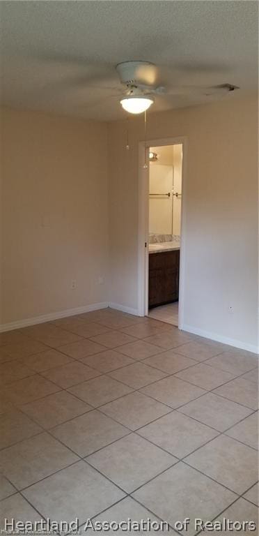 unfurnished room featuring light tile patterned floors and a textured ceiling