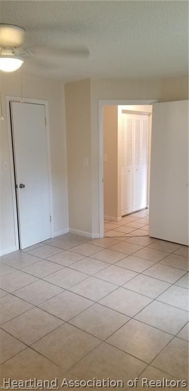 unfurnished room featuring light tile patterned floors and a textured ceiling