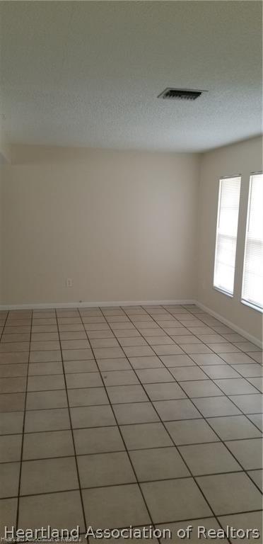 unfurnished room featuring light tile patterned floors