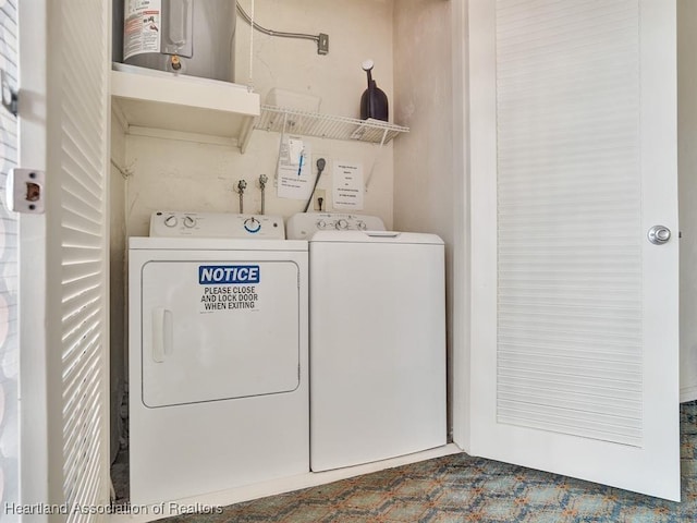 laundry area featuring washing machine and dryer and water heater