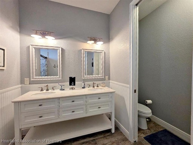 132 Red Water Pt, Lake Placid, FL 33852 - bathroom with double vanity and a wainscoted wall