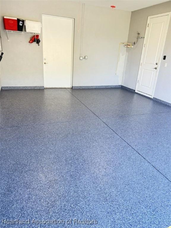 132 Red Water Pt, Lake Placid, FL 33852 - garage featuring baseboards