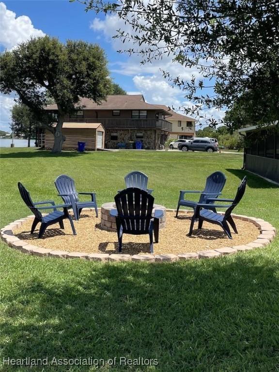 132 Red Water Pt, Lake Placid, FL 33852 - view of green lawn with an outdoor fire pit