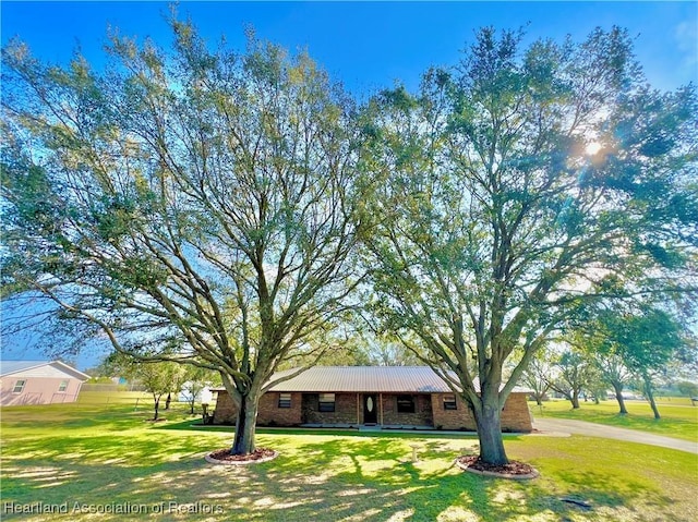 ranch-style home with brick siding and a front lawn