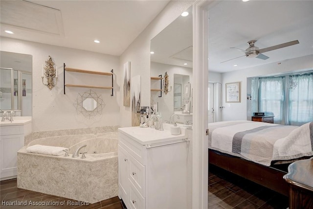 bathroom with plus walk in shower, vanity, and ceiling fan