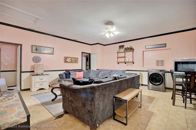 tiled living room with ceiling fan, crown molding, and washer / clothes dryer