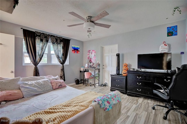 bedroom featuring ceiling fan and light wood-type flooring