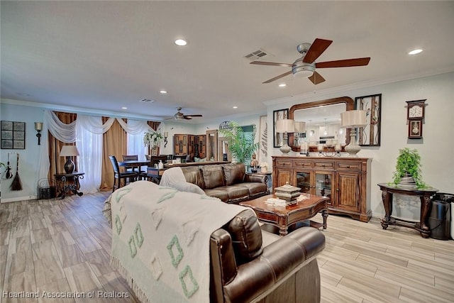 living room featuring ceiling fan and crown molding