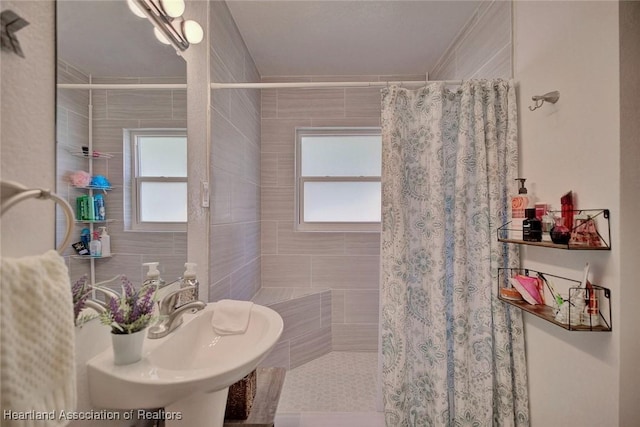 bathroom with a shower with curtain and plenty of natural light