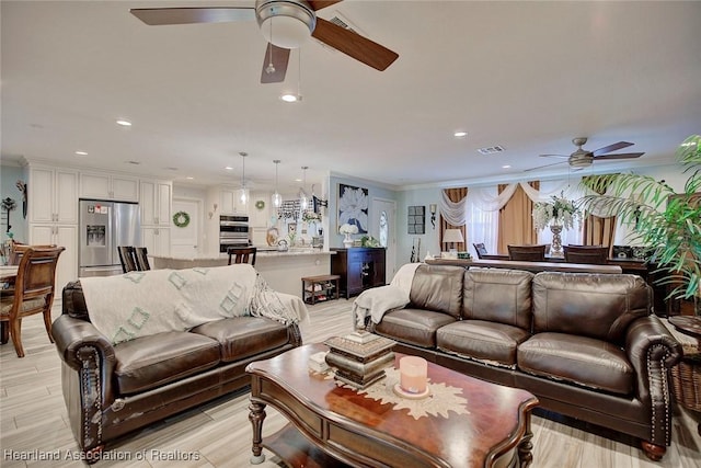 living room featuring ceiling fan and ornamental molding