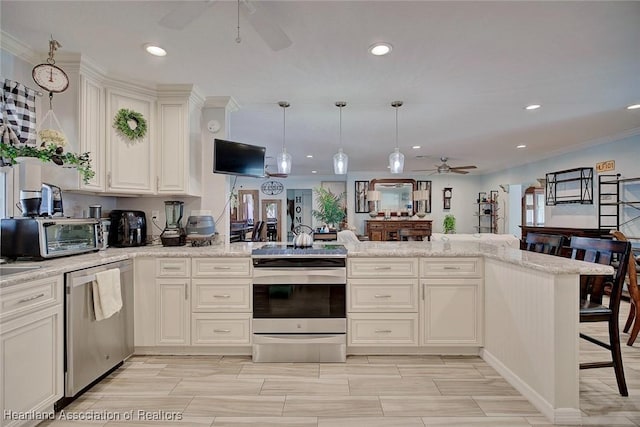 kitchen featuring kitchen peninsula, light stone countertops, decorative light fixtures, and appliances with stainless steel finishes