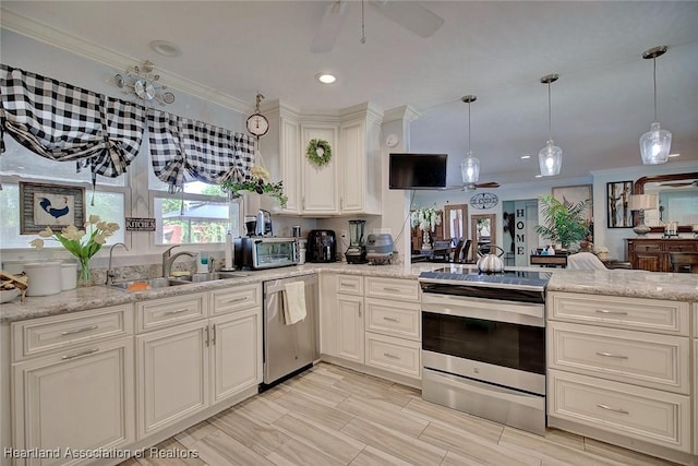 kitchen with ceiling fan, sink, stainless steel appliances, light stone counters, and ornamental molding