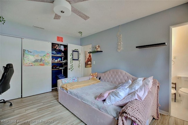 bedroom with a closet, light hardwood / wood-style floors, and ceiling fan