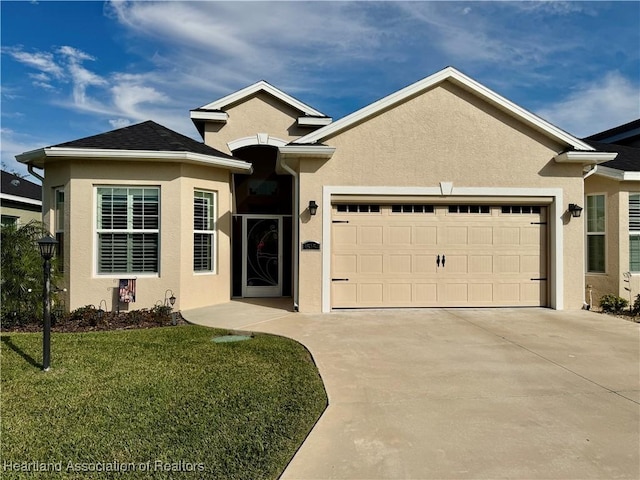 view of front of property with a front lawn and a garage