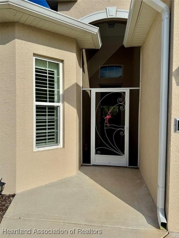 entrance to property with a patio