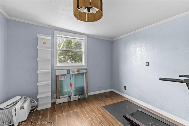 interior space with a wall mounted AC and ornamental molding