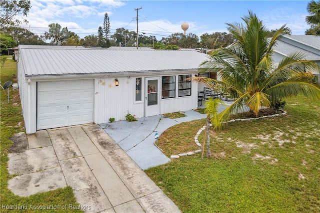 ranch-style home featuring a garage and a front lawn