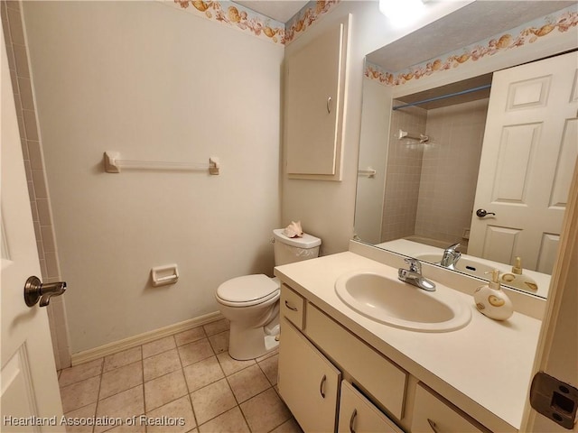 full bathroom with vanity, tile patterned flooring, tiled shower / bath combo, and toilet