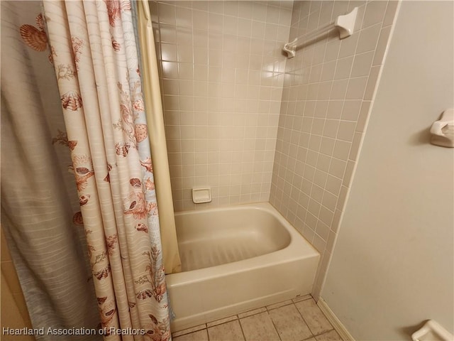 bathroom with tile patterned flooring and shower / bath combo with shower curtain