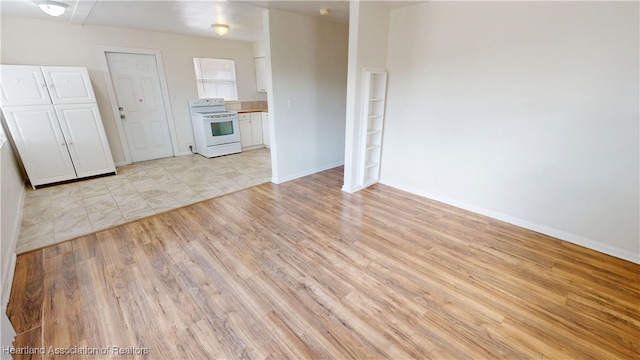 interior space with baseboards and light wood-style floors